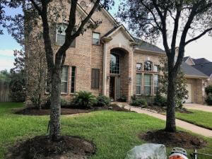 front yard landscape before stone edging mulch houston tx 77407