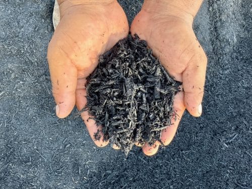 Texas Garden Materials providing black mulch delivery and installation in Houston. Premium black mulch for flower beds, walkways, and landscaping projects, available in bulk with professional installation services.