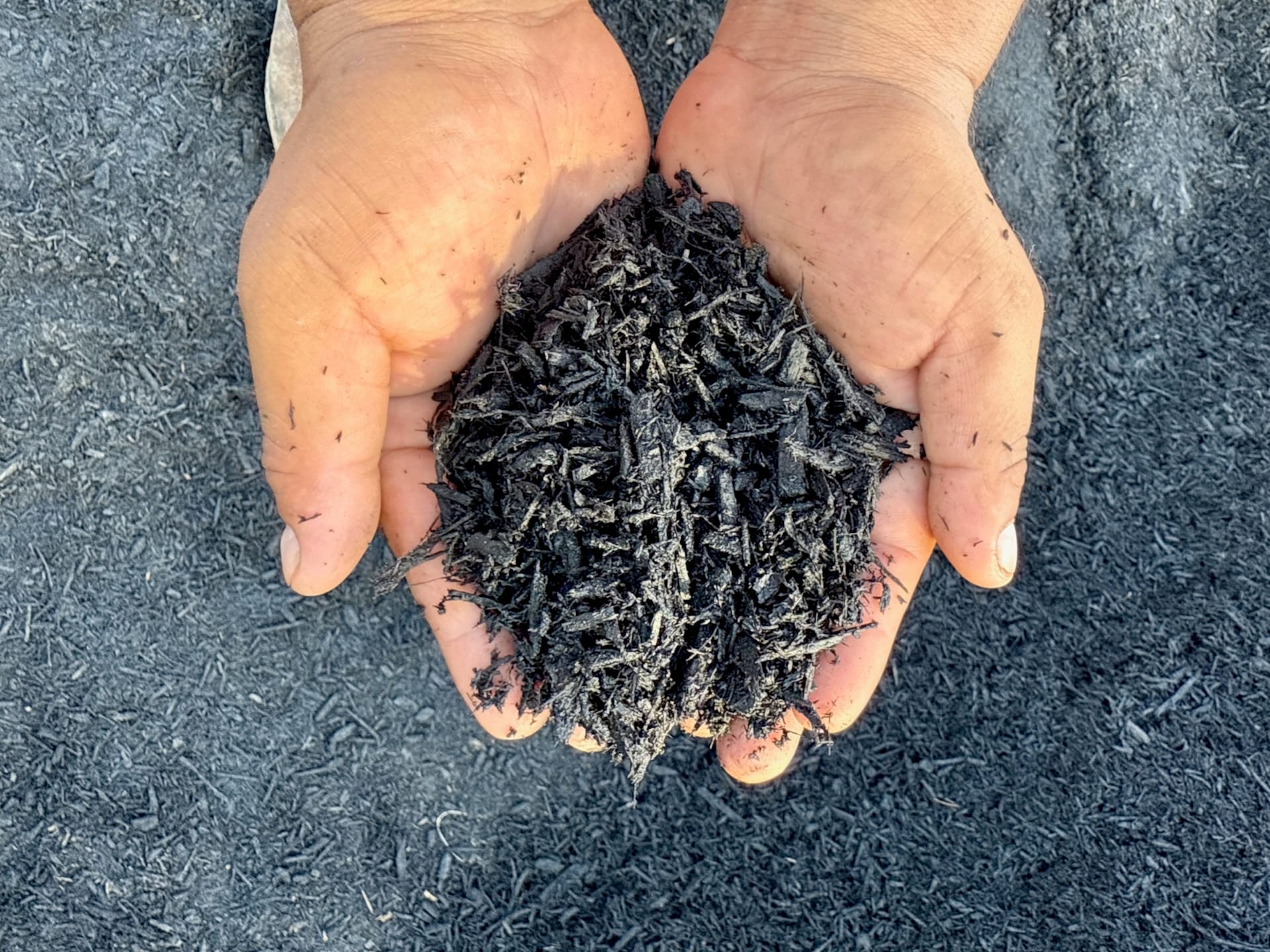 Texas Garden Materials providing black mulch delivery and installation in Houston. Premium black mulch for flower beds, walkways, and landscaping projects, available in bulk with professional installation services.